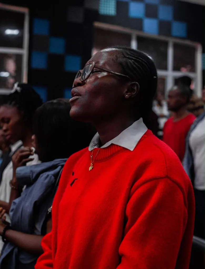 A delegate in prayer during an encounter service at Faith Tabernacle