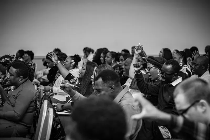 The congregation worshipping with hands raised