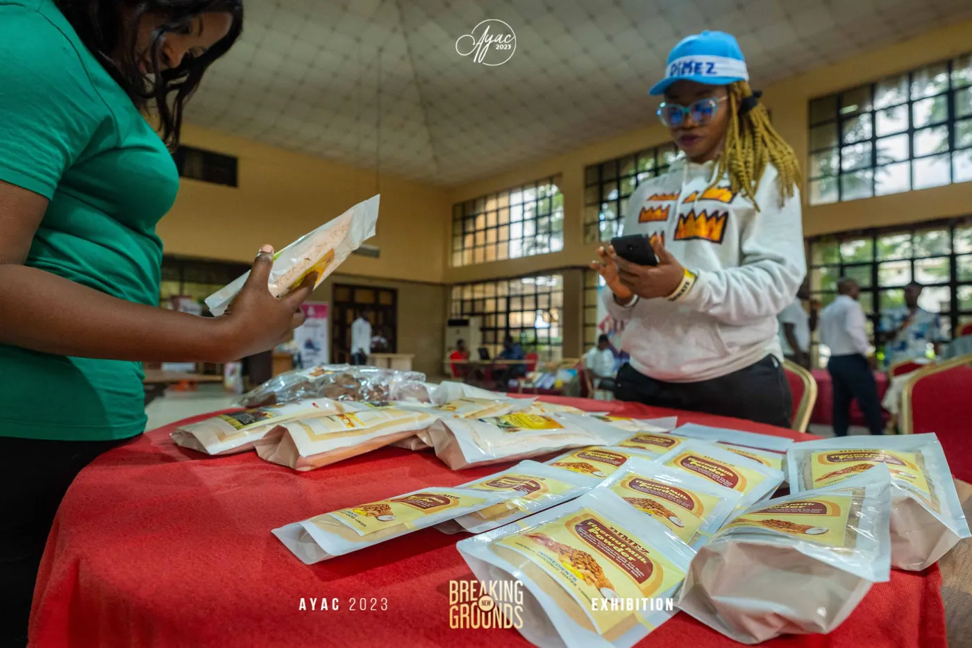 An exhibitor reviewing packaged products at her AYAC stand