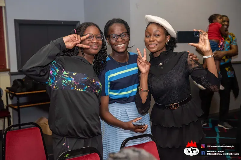 Three friends posing together after the service