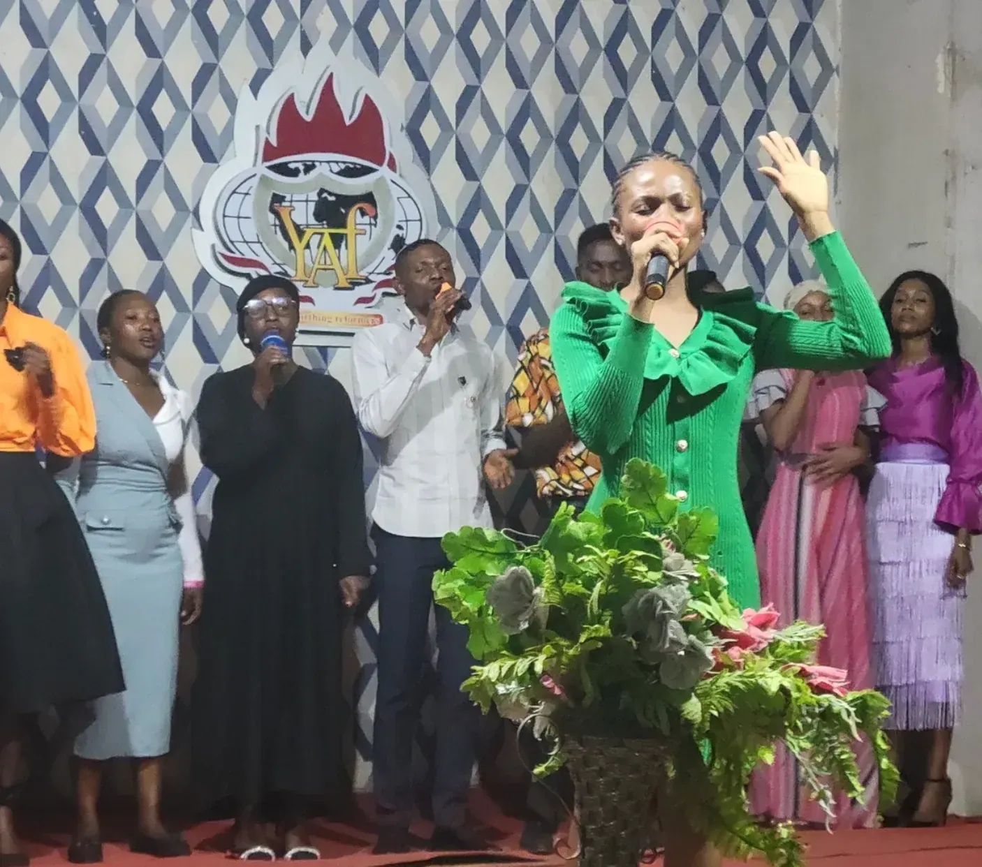 A worship leader singing during a Youth Alive fellowship service in Nigeria