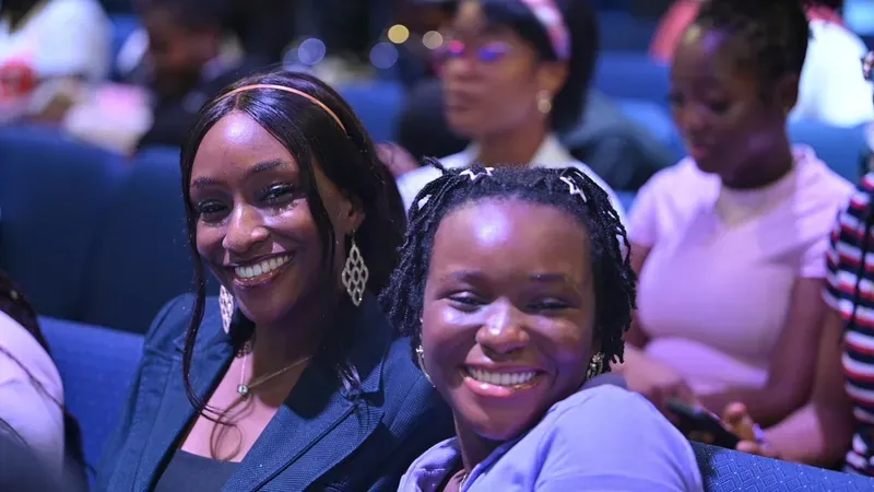 Two friends smiling together in the congregation