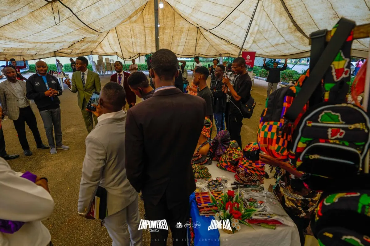 Crowd browsing craft stalls under the job fair tent at Canaanland