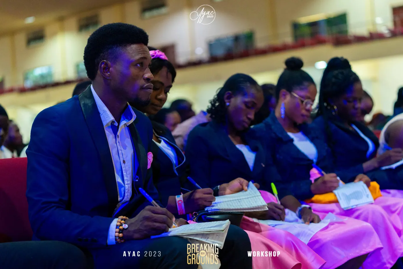 Delegates in suits taking notes during a workshop session