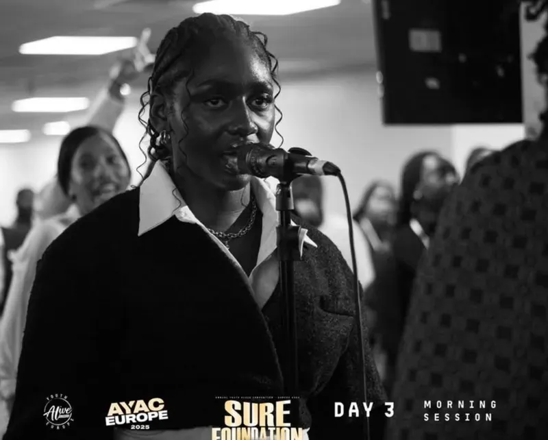 A worship leader singing during the gathering