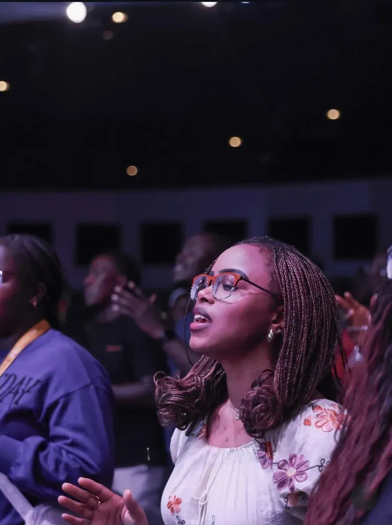 A young woman singing in worship