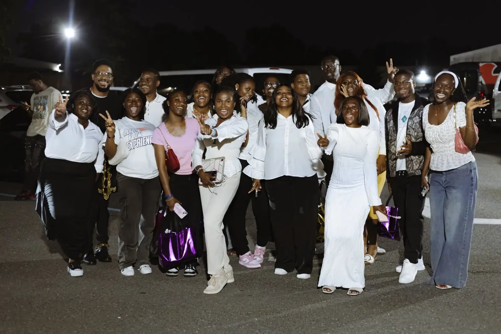 A group of delegates celebrating outside the venue at night